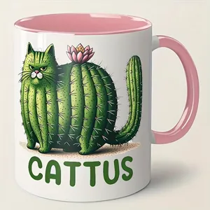 Ceramic coffee mug with cute cactus cat design and pink handle, perfect funny holiday gift.