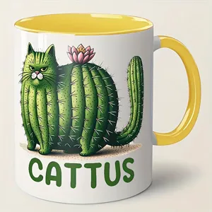 Close-up of ceramic coffee mug featuring funny cactus cat illustration and yellow handle.
