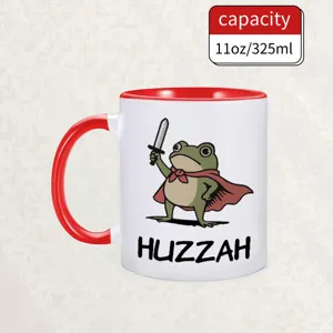 Ceramic coffee mug with funny sword-wielding frog design, 11oz capacity, red accent detail.