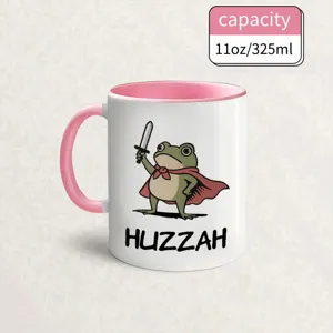 Detail view of funny frog ceramic coffee mug with pink handle, perfect creative gift.