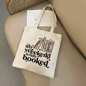 Sac cabas en toile de coton avec imprimé de livres et texte motivant, idéal pour les étudiants.