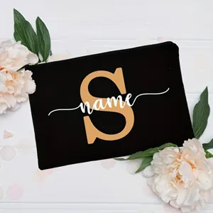 Custom letter black makeup bag with floral background, stylish cosmetic pouch for women.