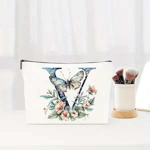 Detail view of the elegant canvas makeup bag featuring floral letter V design and smooth zipper.