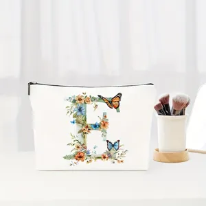 Floral letter E canvas makeup pouch, elegant cosmetic storage bag for travel and gifts.