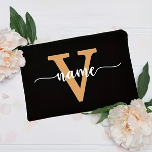 Black canvas makeup pouch with custom gold letter V and white name print for women.