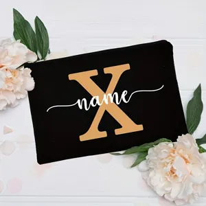Custom initial black cosmetic bag with floral design, personalized letter zipper pouch.