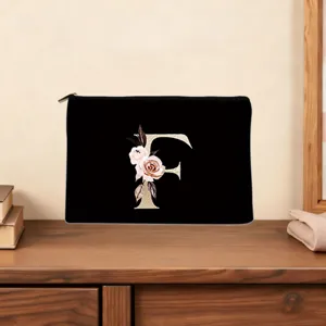 Floral letter F black cosmetic pouch with zipper closure, elegant custom monogram clutch.