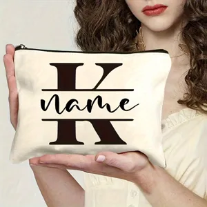 Detail view of customized canvas makeup bag with letter K print and convenient black zipper.