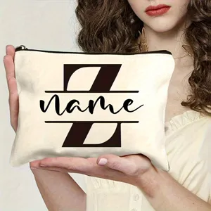 Close-up detail showing the personalized canvas makeup bag with custom letter print design.