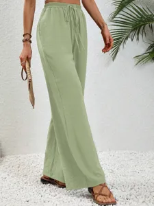 Detail view of women high waist wide leg casual trousers in light green with drawstring.