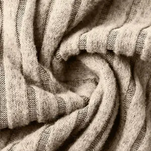 Close-up detail of soft ribbed knit fabric texture, showing cozy winter apparel material quality.