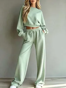 Detailed view of light green casual cropped sweatshirt and wide-leg lounge pants set.