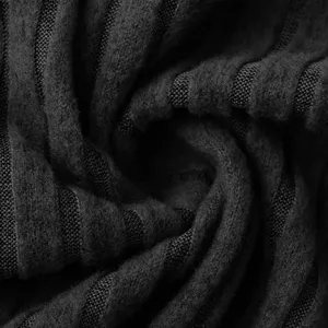 Close-up detail of black ribbed knit fabric showing soft texture and cozy knit pattern.