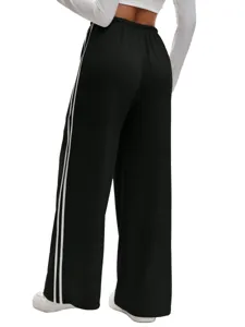 Black wide-leg sweatpants detail with white side stripes and comfortable high-waist fit.