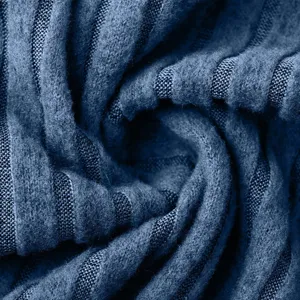 Detailed close-up shot of dark blue ribbed knitted fabric texture with soft swirl pattern.