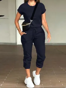 Women casual solid color short sleeve t-shirt and jogger pants set with pockets for daily wear.
