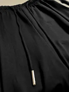 Detailed view of women's casual pants featuring a comfortable drawstring elastic waist.