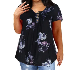 Floral print detail view of plus size short sleeve top with button placket and pleats.