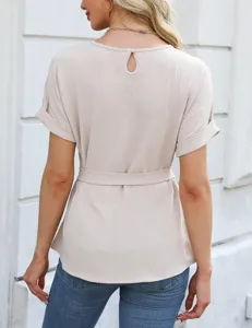Back detail of casual beige short sleeve blouse with keyhole button and matching waist tie.