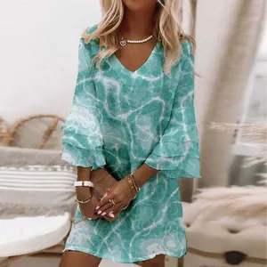 Close-up detail of the teal water ripple print V-neck 3/4 bell sleeve mini dress design.