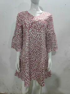 Detailed view of the V-neck mini dress with 3/4 layered sleeves and stylish abstract print pattern.
