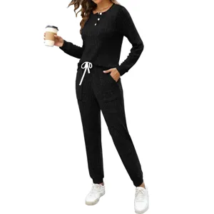 Detail view of women's black ribbed two-piece lounge set, long sleeve henley top and pants.