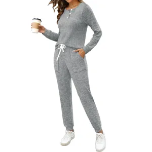 Ribbed grey two-piece loungewear set detail, long sleeve button top and pocket jogger pants.
