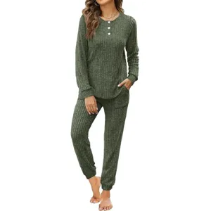 Detailed view of the dark green ribbed long sleeve button top and matching pocket sweatpants.