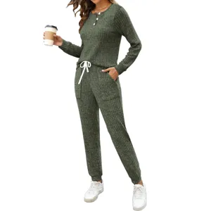 Detail view of the dark green ribbed two-piece lounge set, featuring buttons and pockets.