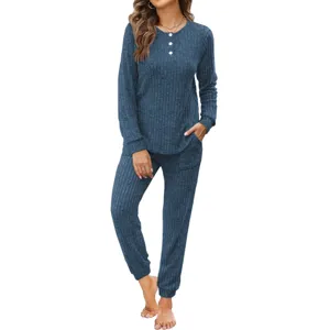Close-up of blue ribbed loungewear set, featuring long sleeve button top and pocket pants.