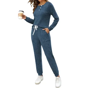 Casual ribbed two-piece loungewear set featuring a buttoned long sleeve top and pocket pants.