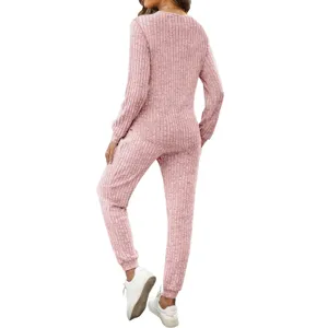 Back view of women pink ribbed two piece loungewear set with long sleeve top and pants.