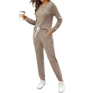 Khaki ribbed two-piece lounge set detail, featuring button-front top and pocket jogger pants.