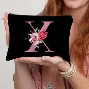 Black canvas cosmetic bag with pink glitter letter X floral design for women storage.
