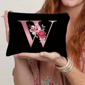 Black canvas cosmetic bag with rose gold letter W and floral design for women daily use.