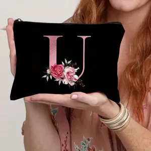 Black canvas cosmetic bag with rose gold letter U and floral print for daily makeup storage.