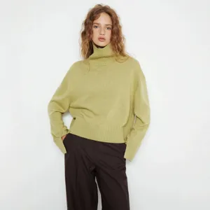 Detail shot of women's casual loose turtleneck knit sweater, soft fabric, elegant autumn wear.