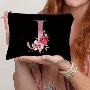 Detailed view of the black canvas cosmetic pouch featuring a rose gold letter J and floral print.