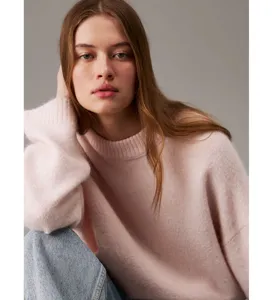 Detailed view of the soft pink crewneck knit sweater, showing fine texture and cozy fit.