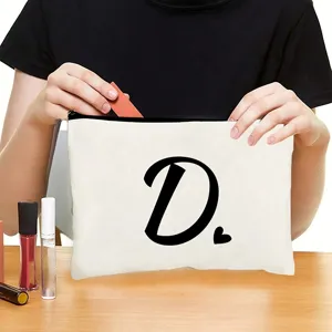 White canvas zipper cosmetic bag featuring a bold black letter D print and a cute heart detail.
