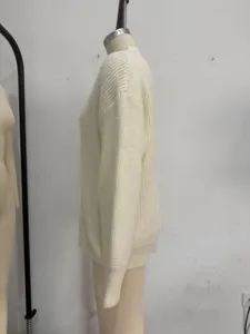 Detail view of a beige V-neck loose knit sweater for women, showcasing side fit and texture.