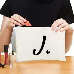 White canvas cosmetic bag with black letter J print, zipper pouch for travel makeup storage.