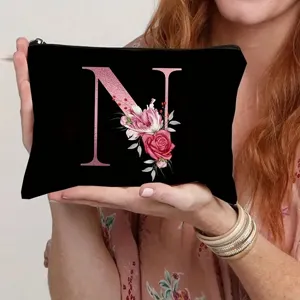 Black canvas cosmetic bag with floral letter N, stylish makeup pouch and coin purse for women.