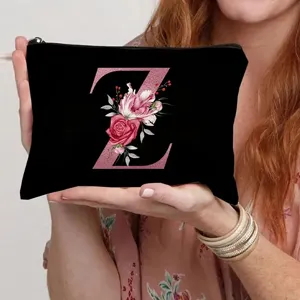 Black canvas cosmetic bag with pink floral letter Z print, portable zipper pouch.