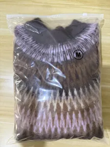 Detailed view of the fuzzy Fair Isle crewneck sweater in knit geometric pattern.
