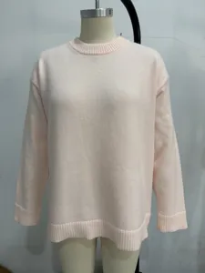 Close-up view of a soft pink knit sweater featuring a cozy crewneck and relaxed fit design.