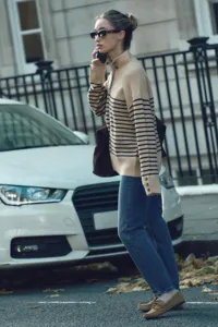Chic striped turtleneck sweater for women, cozy knitwear with button detail for autumn styling.