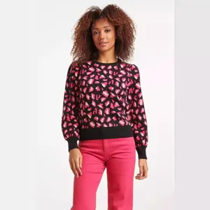 Detailed view of women's black and pink leopard print crewneck knit sweater, autumn fashion wear.