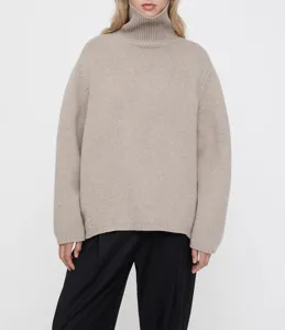 Close-up detail view of a cozy oatmeal turtleneck wool blend sweater in a relaxed fit.