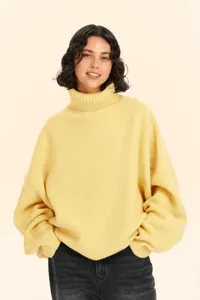 Yellow turtleneck knit sweater detail, cozy winter apparel, soft fabric close-up view.